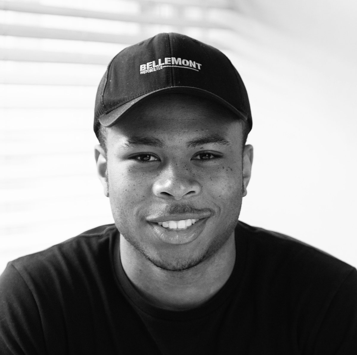 Portrait of Tobenna “Toby” Ilogu in a BELLEMONT cap